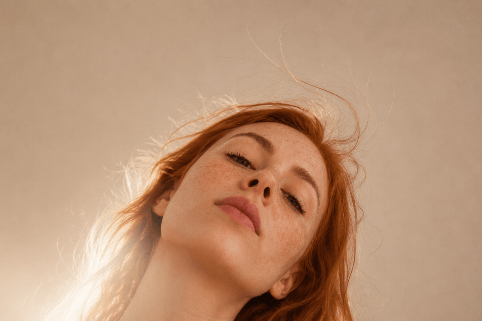 Close-up of a person with red hair against a beige background Suvera Skincare, vegan skincare, nut-free skincare