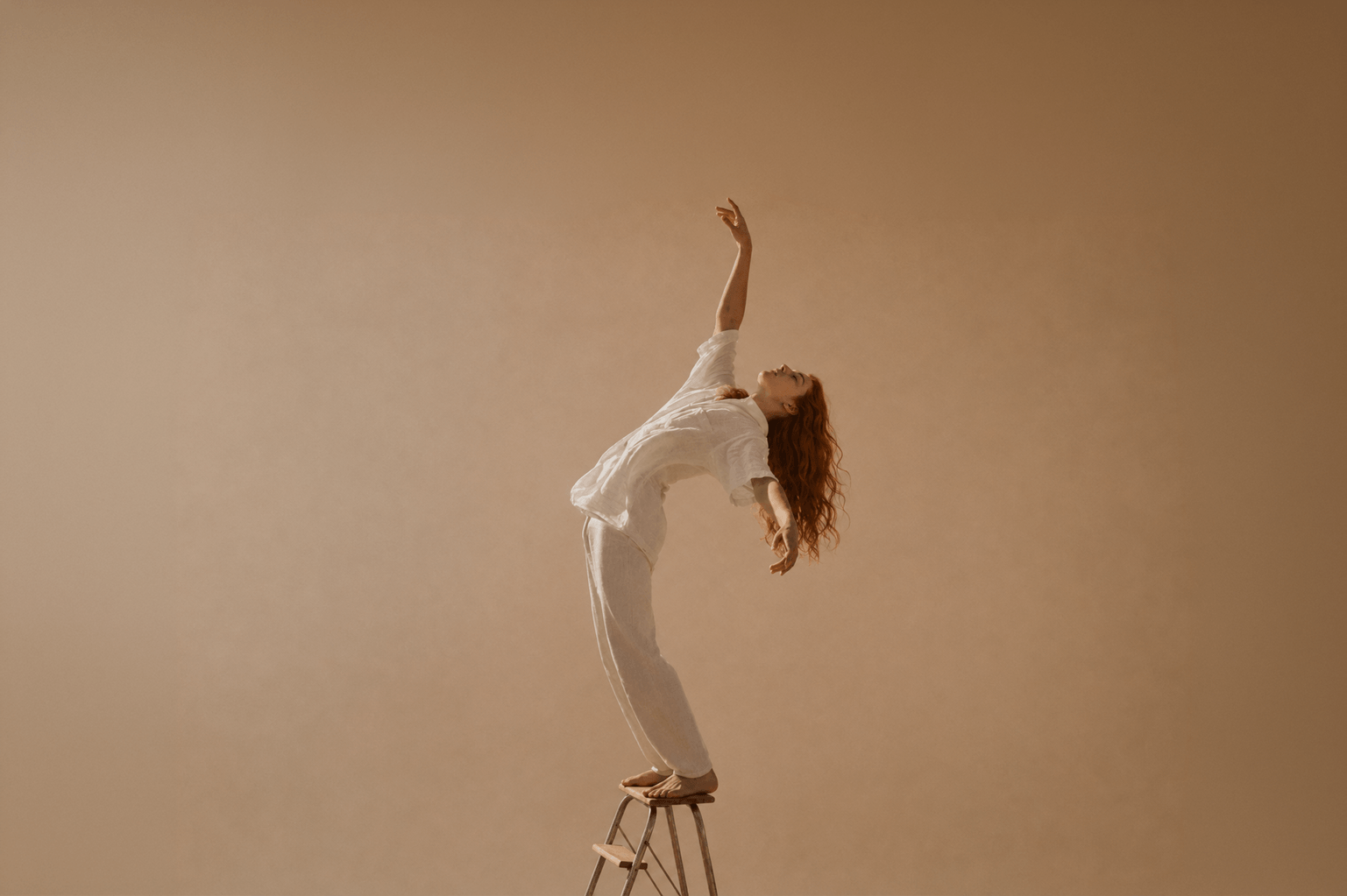 Young lady doing aerobics on a stool in front of a brown wall for Suvera 100% Natural clay masks and oils