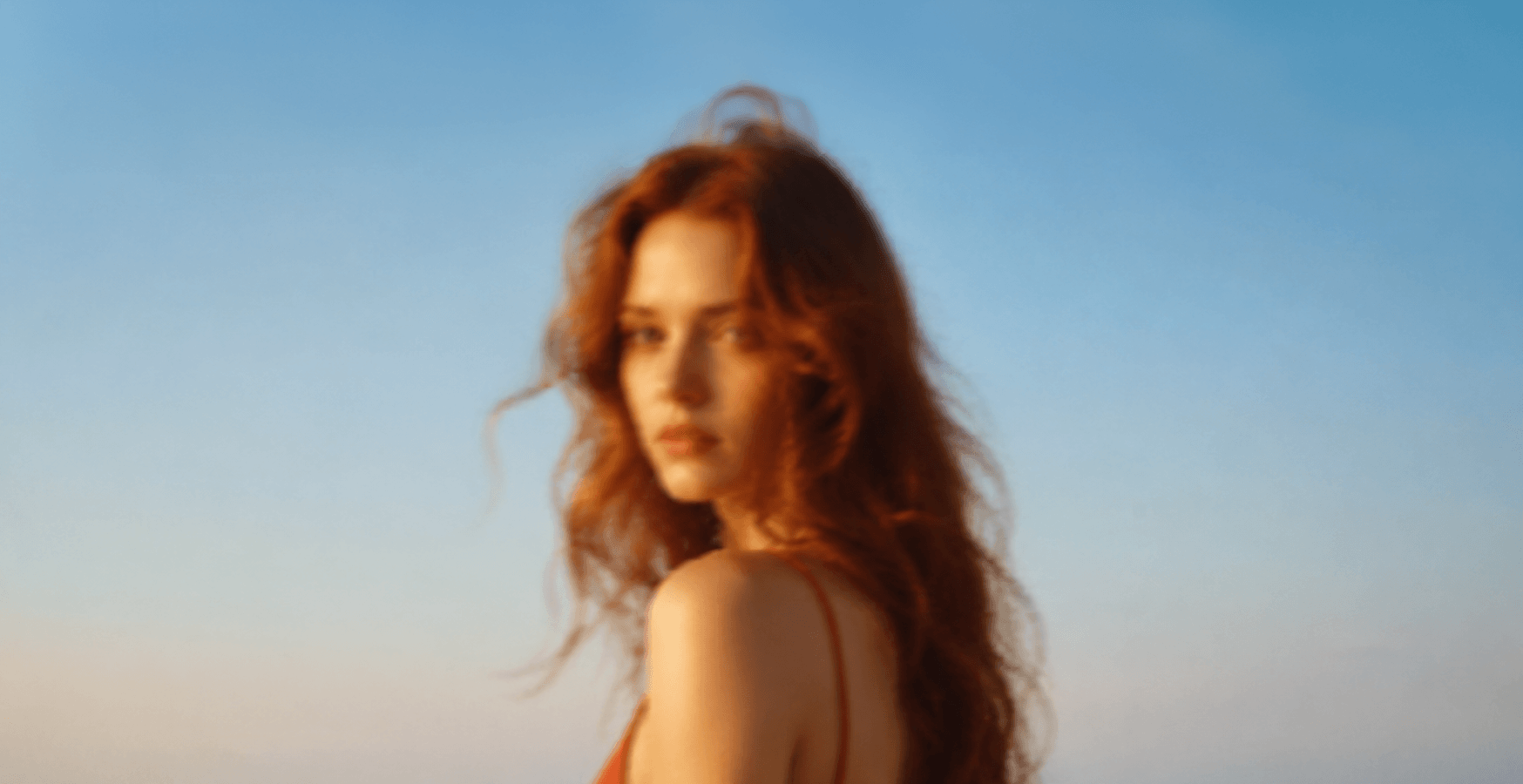 Woman with long hair standing on a beach with a clear sky Suvera Skincare, natural vegan skincare, luxury skincare