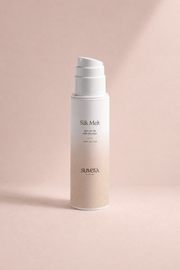 Skincare bottle labeled 'Silk Melt' by Suvera on a pink background Suvera Skincare, conscious beauty