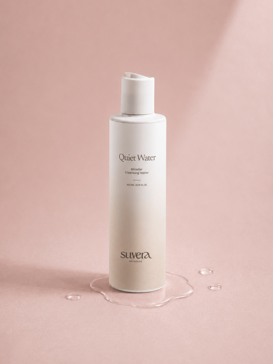 Suvera 'Quiet Water' bottle on a pink background Suvera Skincare, Bureau Veritas certified, natural vegan skincare