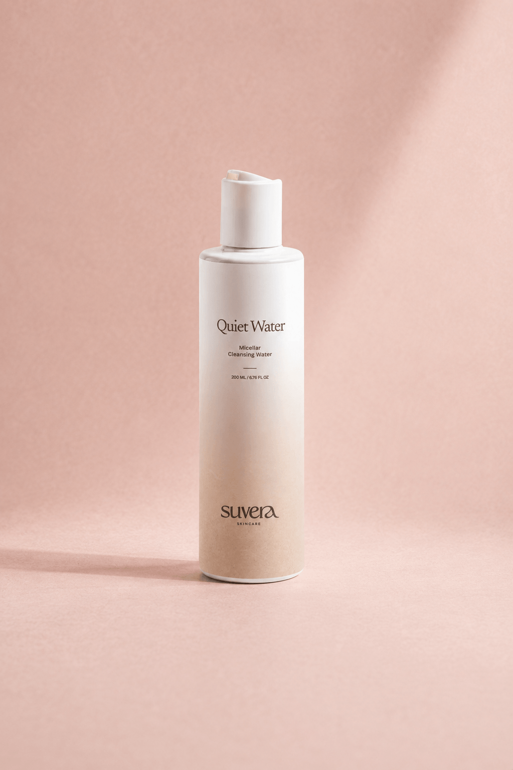 White bottle labeled 'Quiet Water' by Suvera on a pink background Suvera Skincare, skincare rituals, vegan skincare