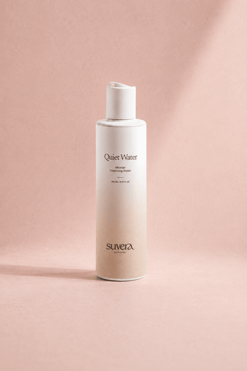 White bottle labeled 'Quiet Water' by Suvera on a pink background Suvera Skincare, skincare rituals, vegan skincare