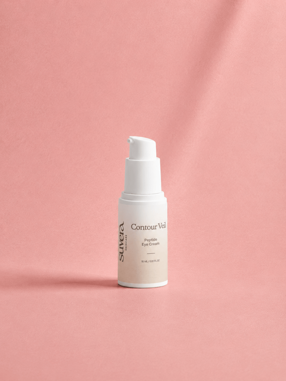 Skincare bottle labeled 'Su:era Contour Visage' on a pink background Suvera Skincare, natural vegan skincare