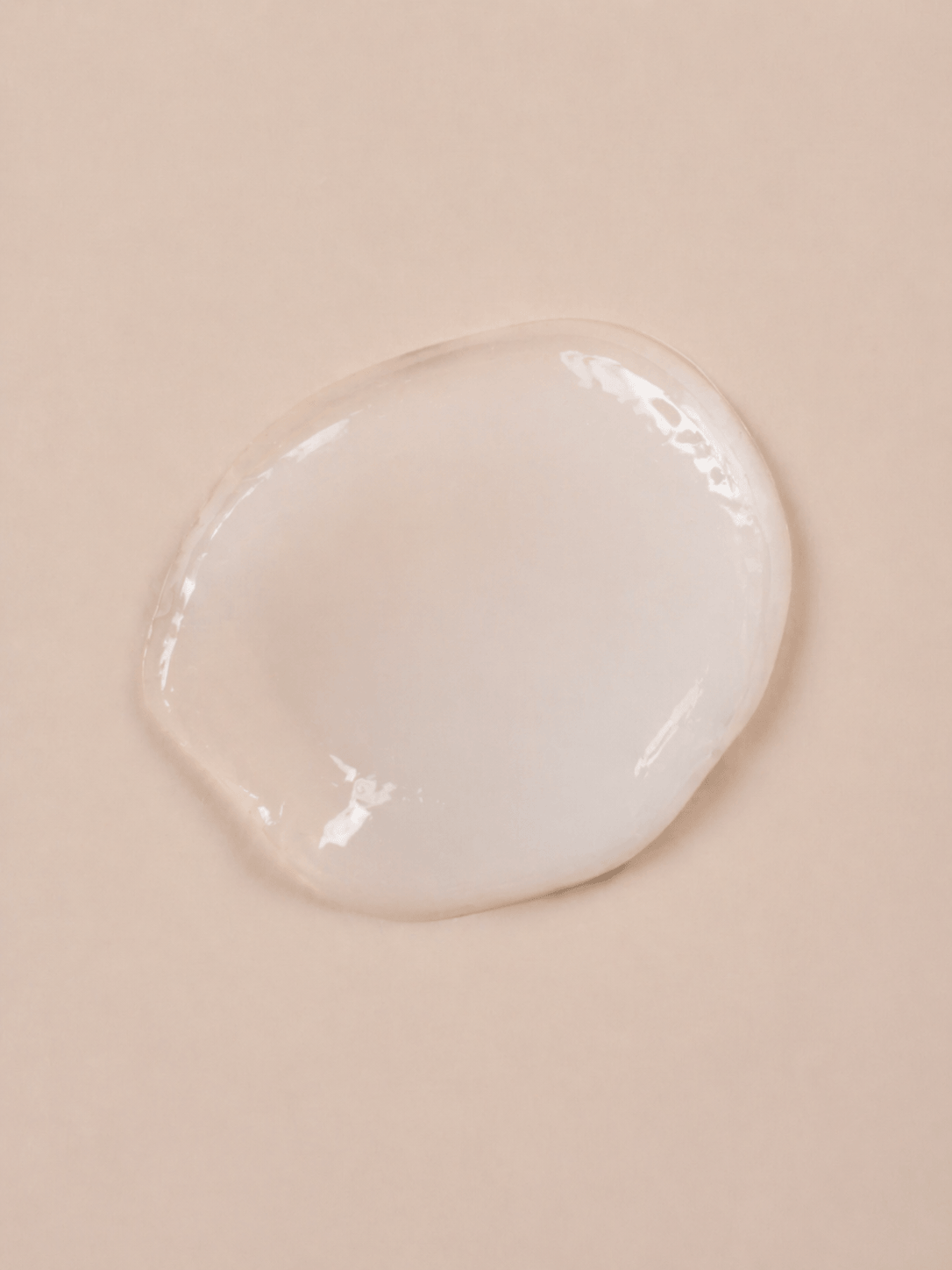 Clear glass skincare cream texture on a beige background Suvera Skincare, local skincare brand, natural beauty, vegan skincare