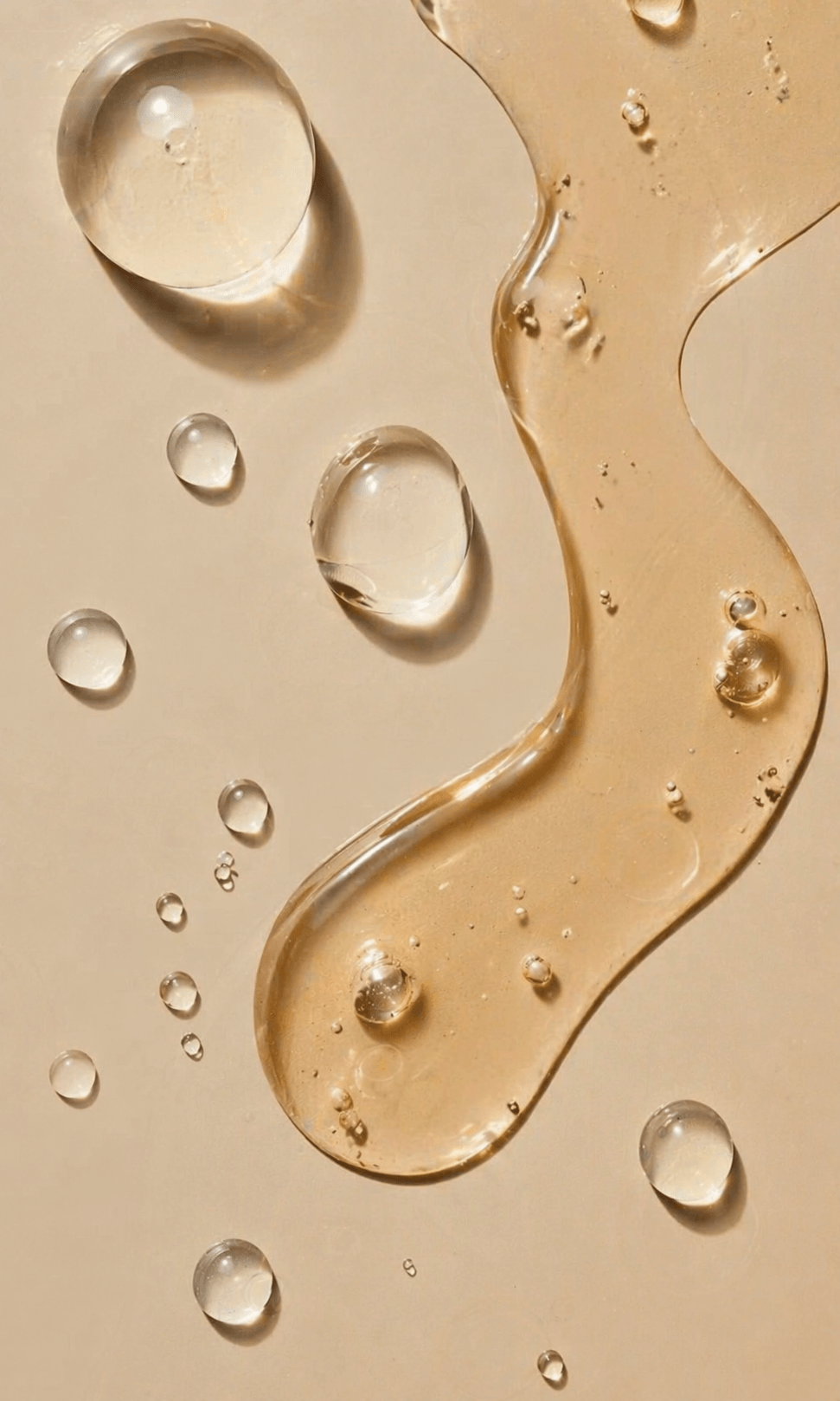 Close-up of liquid droplets and smears on a beige background Suvera Skincare, anti-wrinkle skincare, healthy-looking skin, vegan beauty