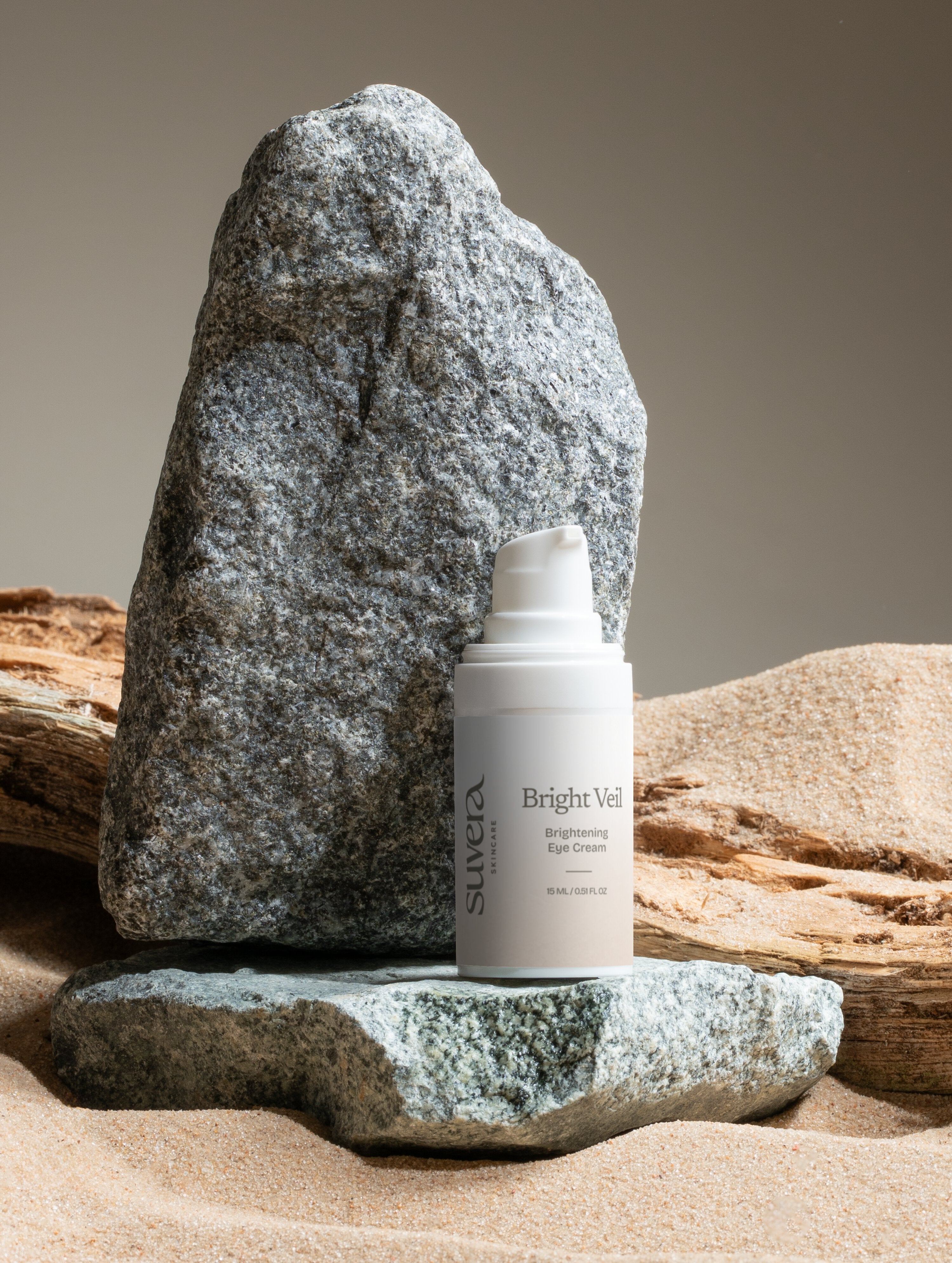 E.J. Blue eye cream bottle on a rock with a natural background Suvera Skincare, COSMOS certified skincare, vegan skincare