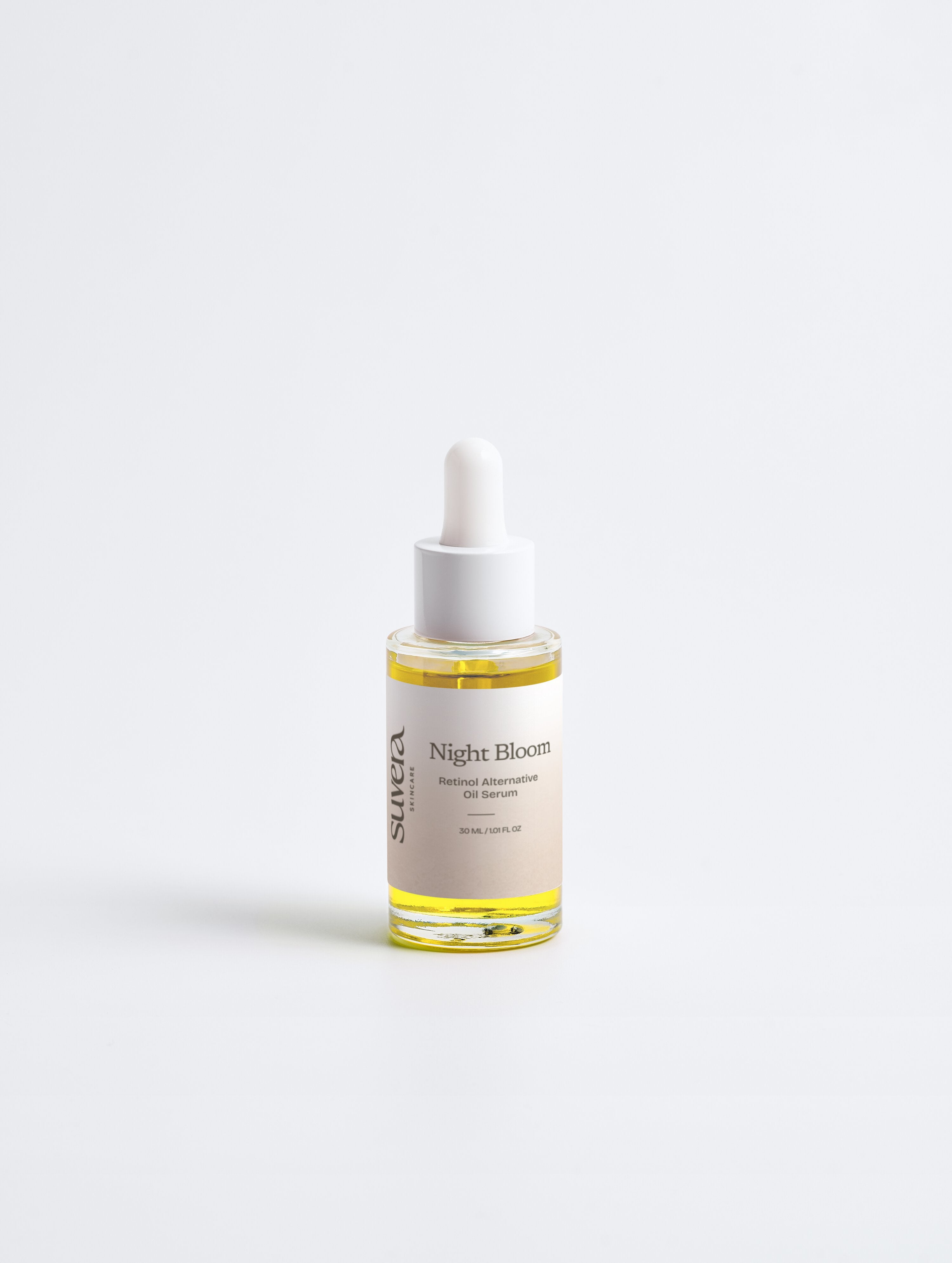 Skincare dropper bottle labeled 'Night Bloom' on a white background Suvera Skincare, Bureau Veritas certified, natural vegan skincare